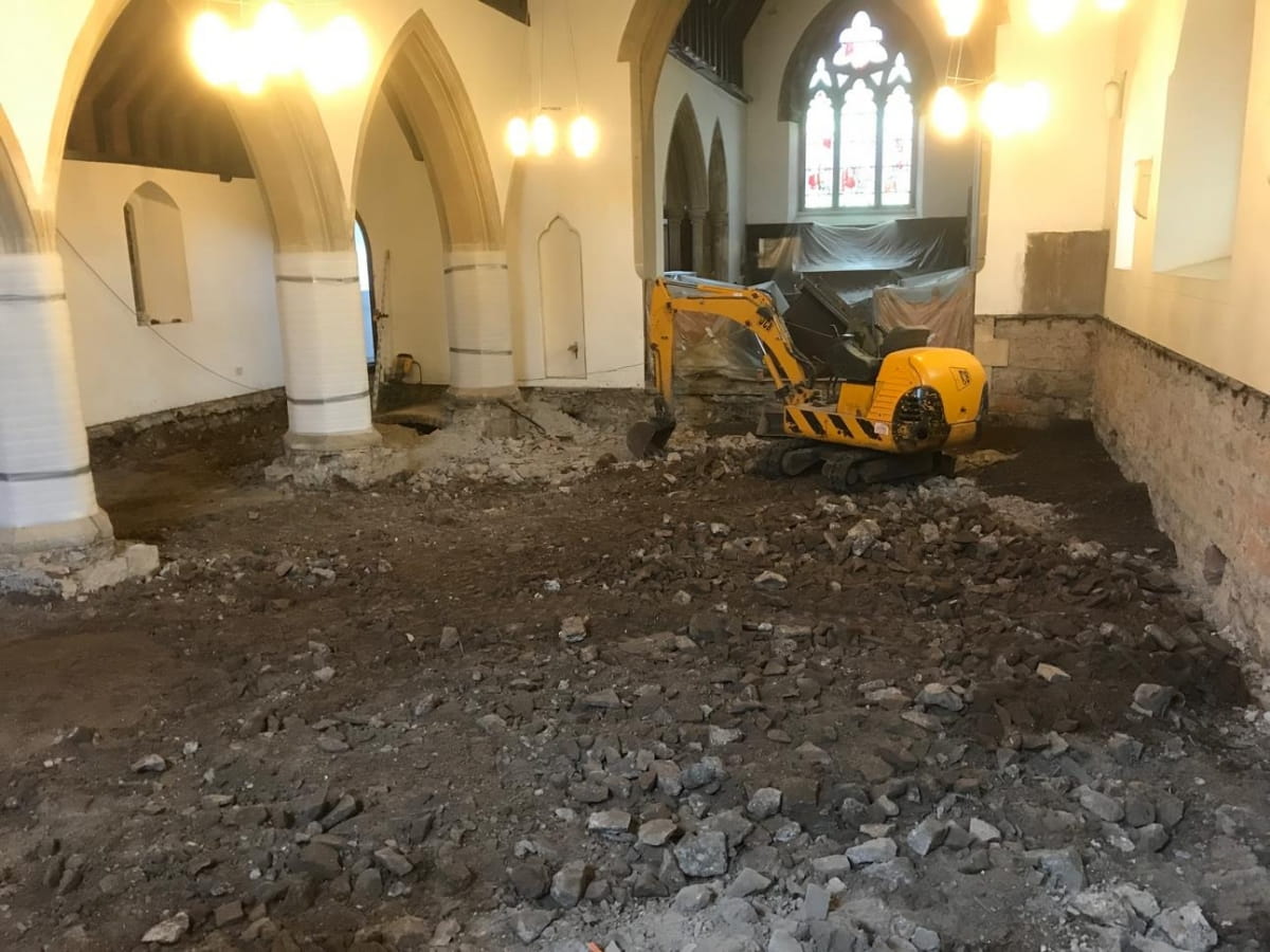 Mini-digger inside church